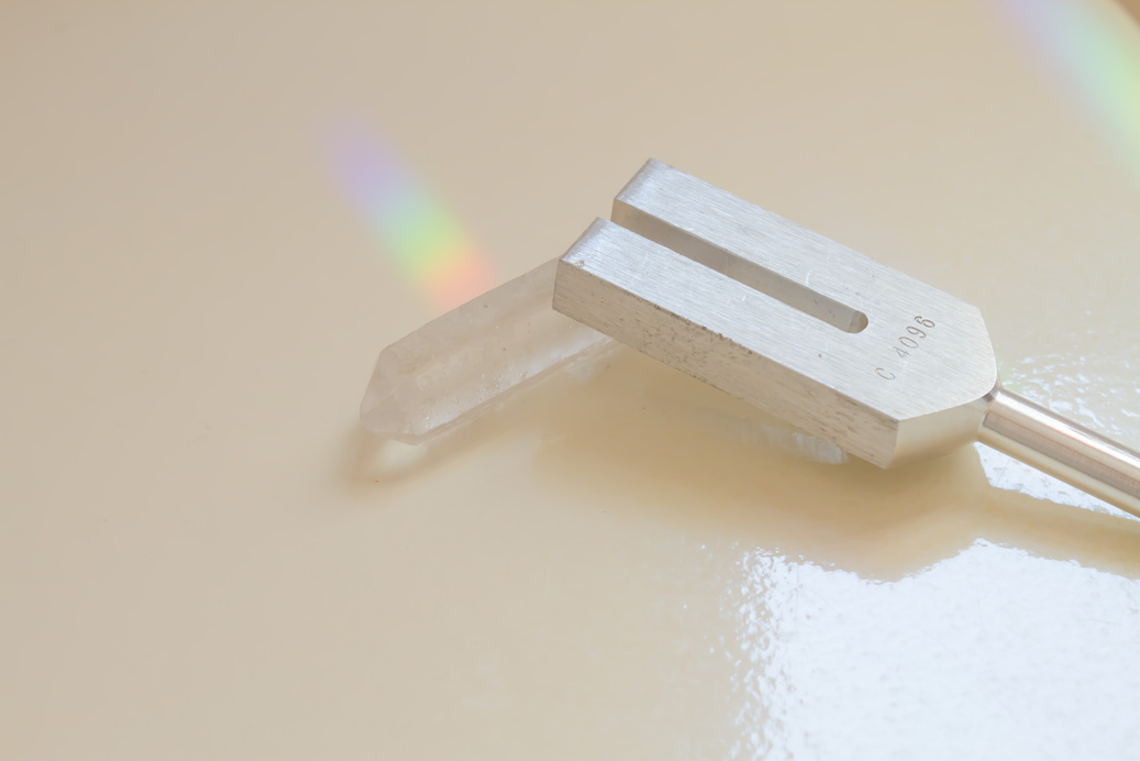 tuning fork and crystal on table .